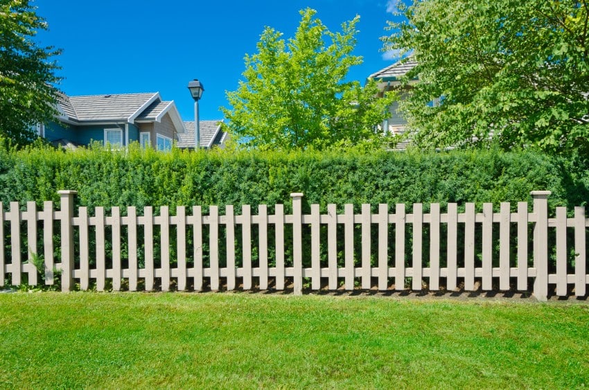 Country style long wooden fence in the backyard.