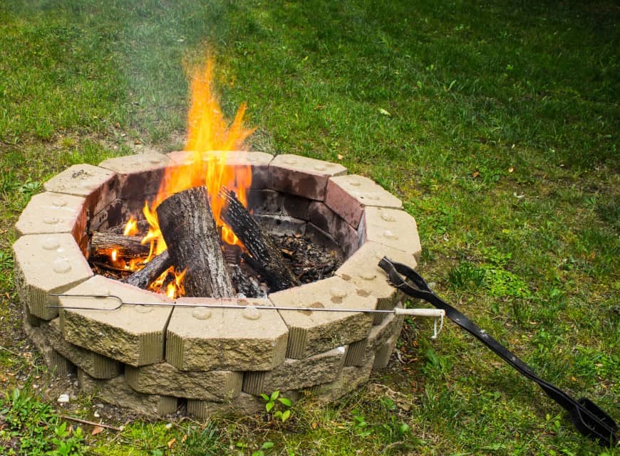 firepit in middle of grass backyard