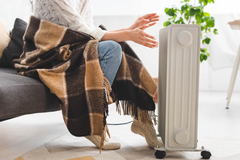 woman in front of space heater
